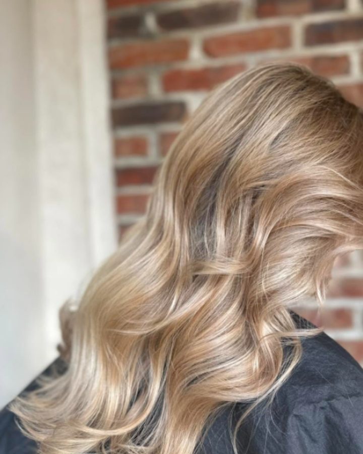 Soft beige blonde balayage in brushed-out waves