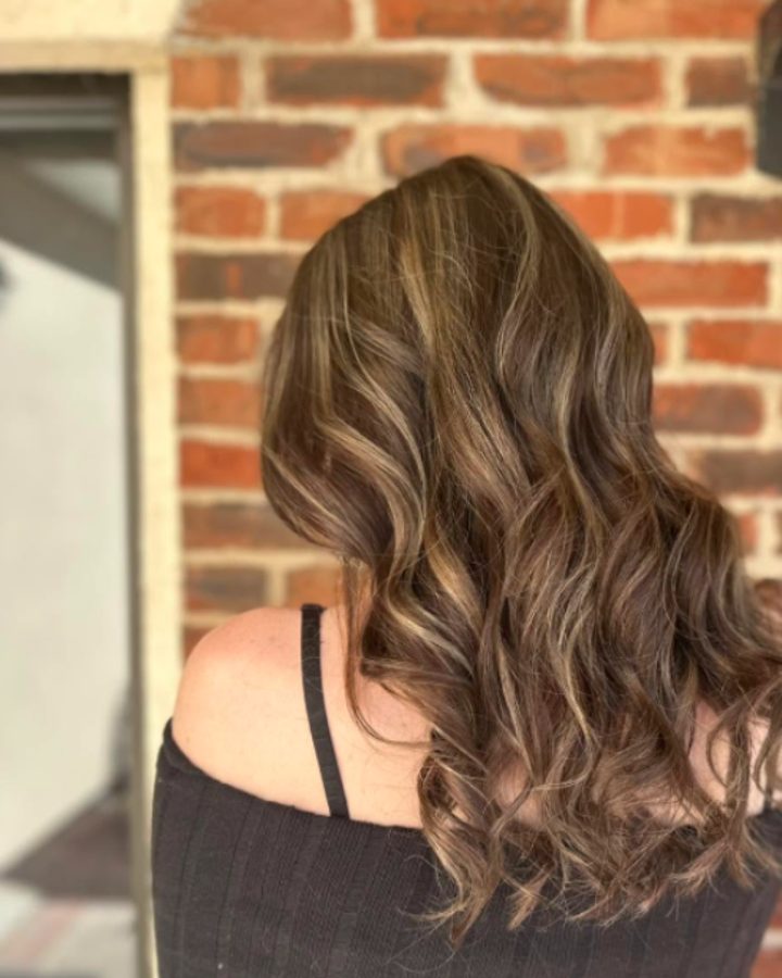 Brunette balayage with caramel ribbons in soft waves, back view