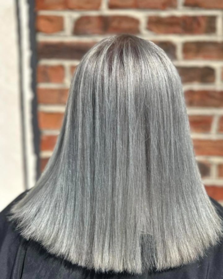 Straight silver lob, seen from behind against brick