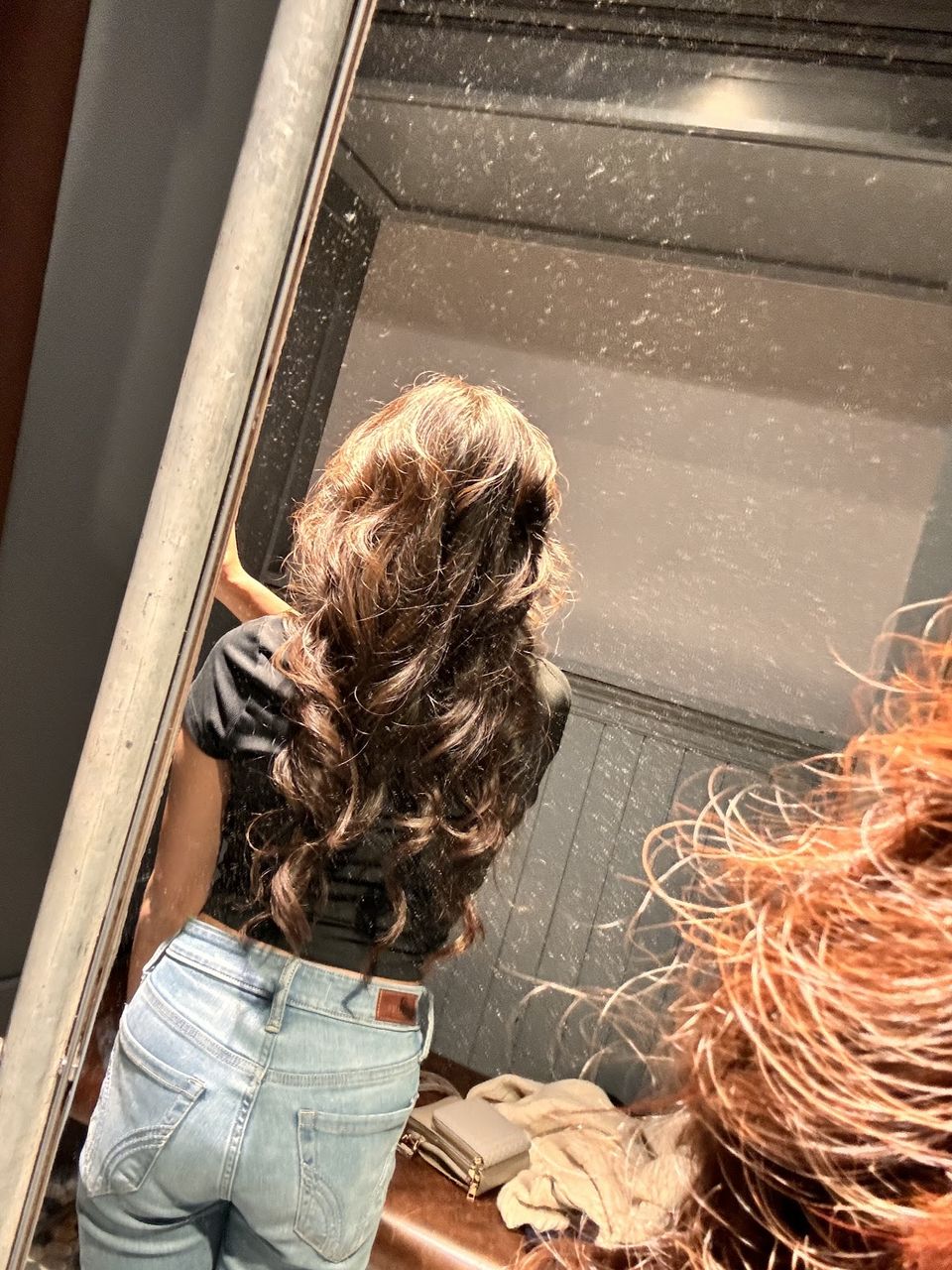 Long layered brunette hair styled in soft waves