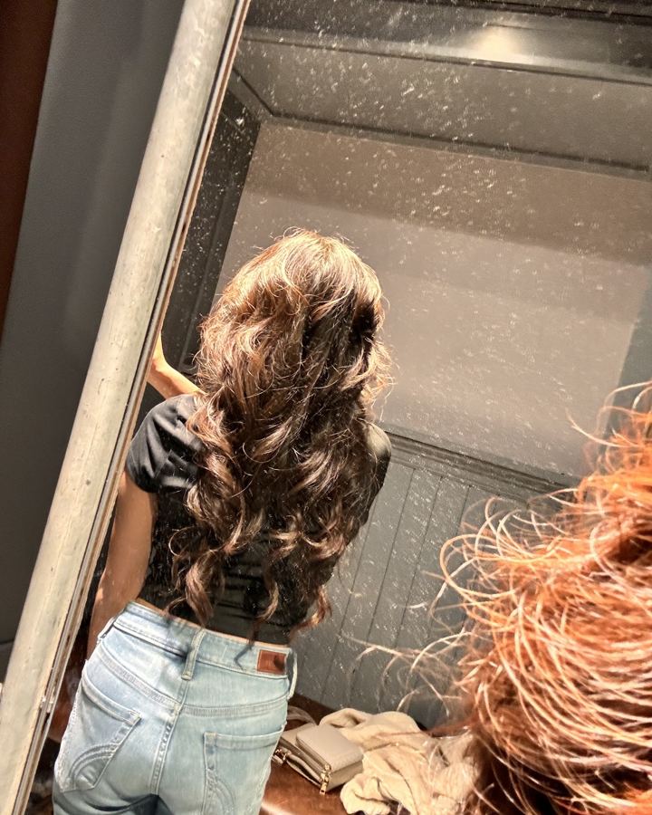 Long brunette waves after a color and style at Curl Up And Dye